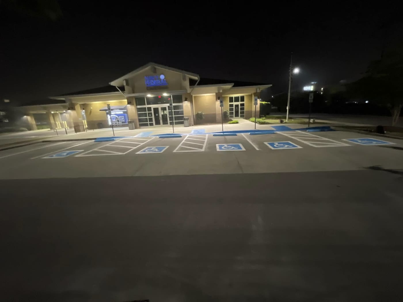 Fresh ADA stalls in front of a building at night