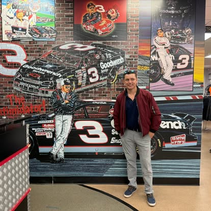 Billy in front of a number 3 race car mural